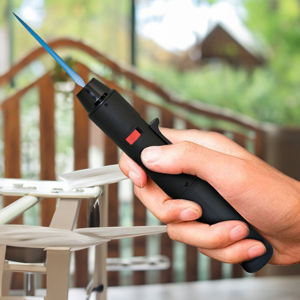 Gas torch with a blue jet flame on butane gas
